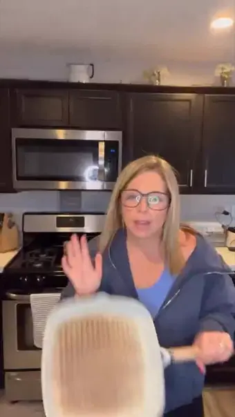 Avatar holding a grill pan in a kitchen