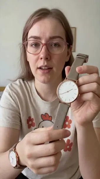Avatar showing a wristwatch to camera
